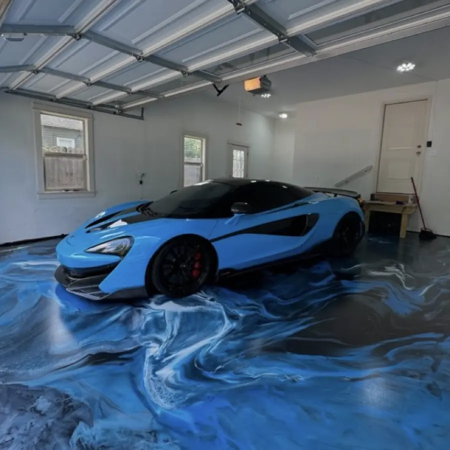 Blue and white swirled epoxy garage floor with a McLaren